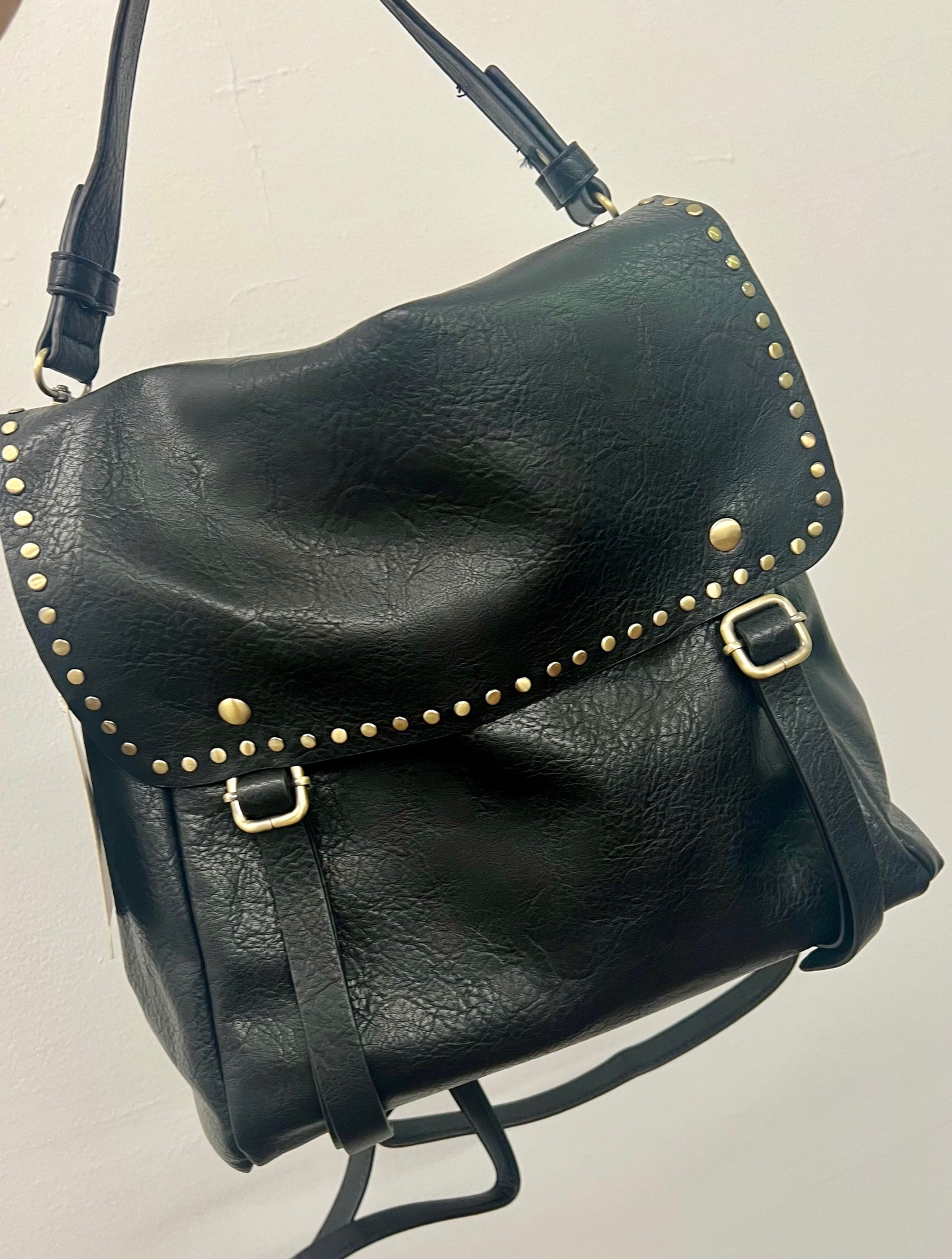 A Backpack that can also be carried as a purse! This lightweight bag is a great transition bag and has a stunning gold studded detail! Available in two colors!